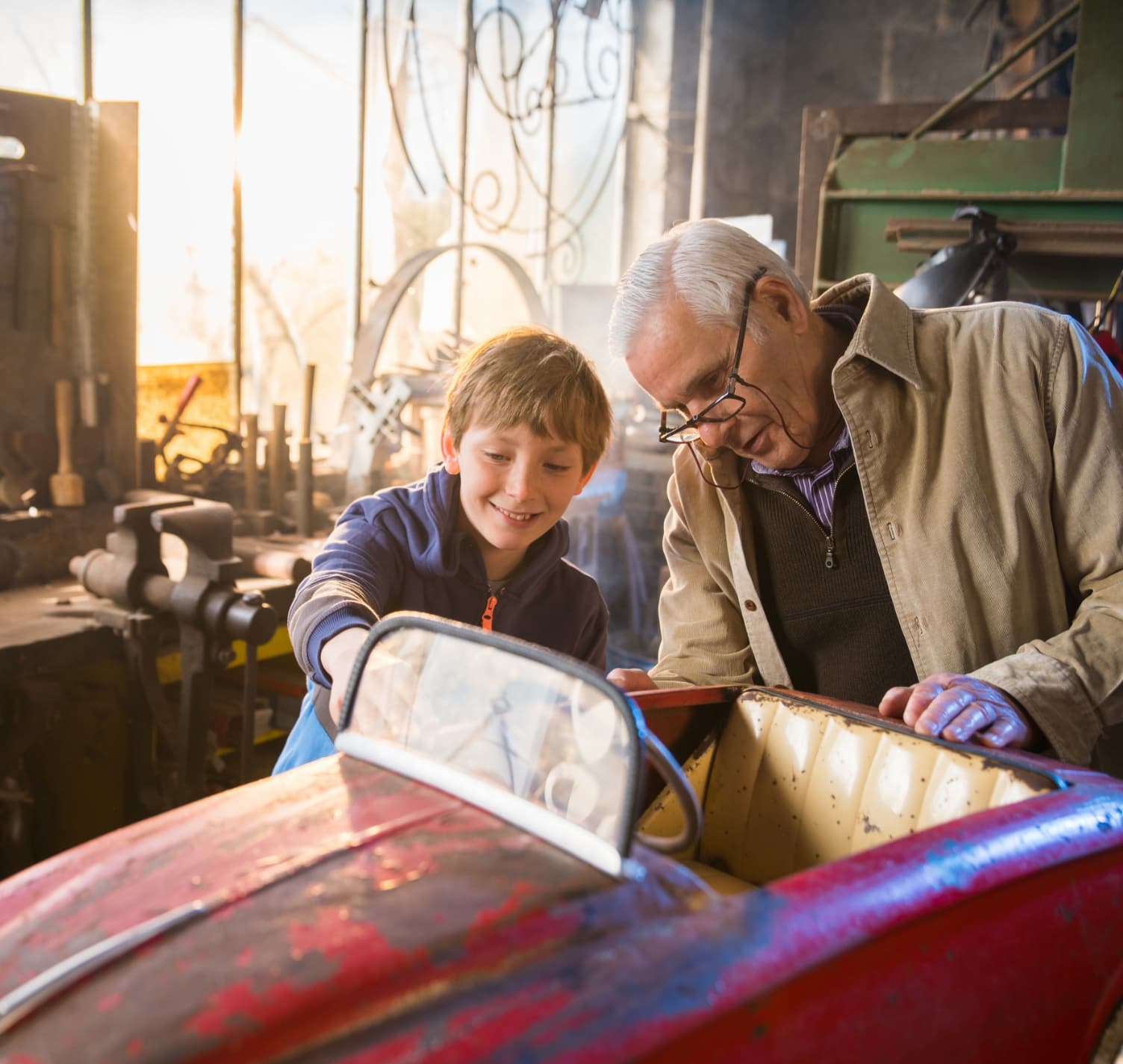 Grandfather and Grandson working on a toy model car